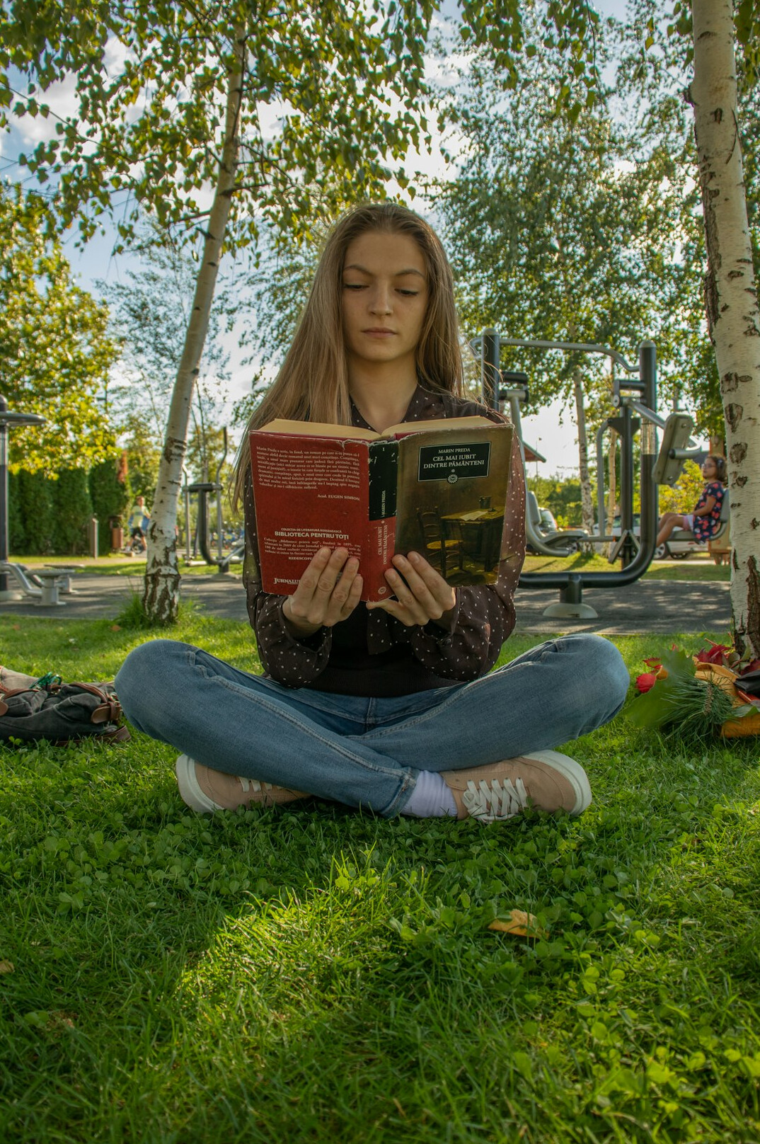 person reading book in park
