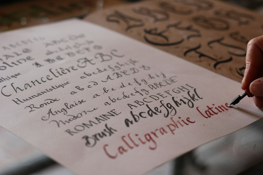 Hands writing observational notes on paper with a fountain pen